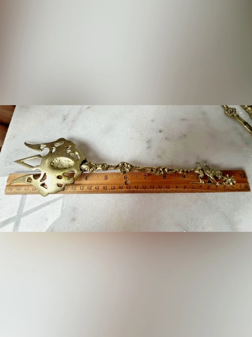 vintage Italian serving utensils are an ornate brass fork and spoon set